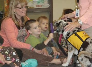 Loki helping children